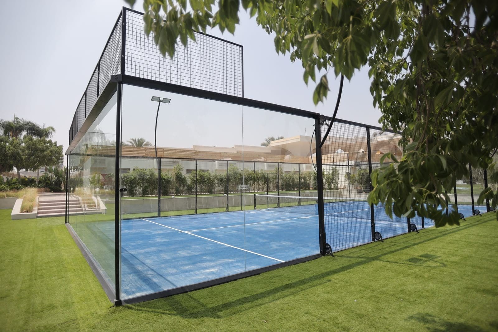 A padel court set among the resort gardens